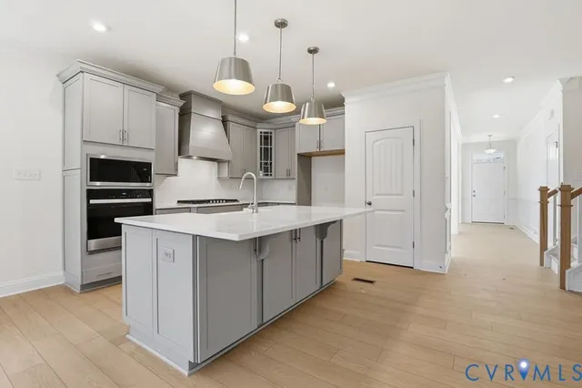 a open kitchen with cabinets a sink and stainless steel appliances