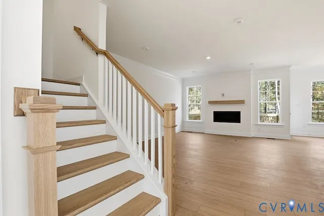 a view of a livingroom with wooden floor and fireplace