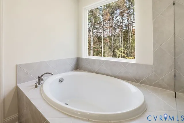 a bathroom with a bathtub and a window