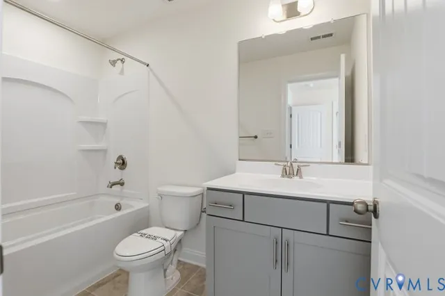 a bathroom with a sink toilet vanity and shower