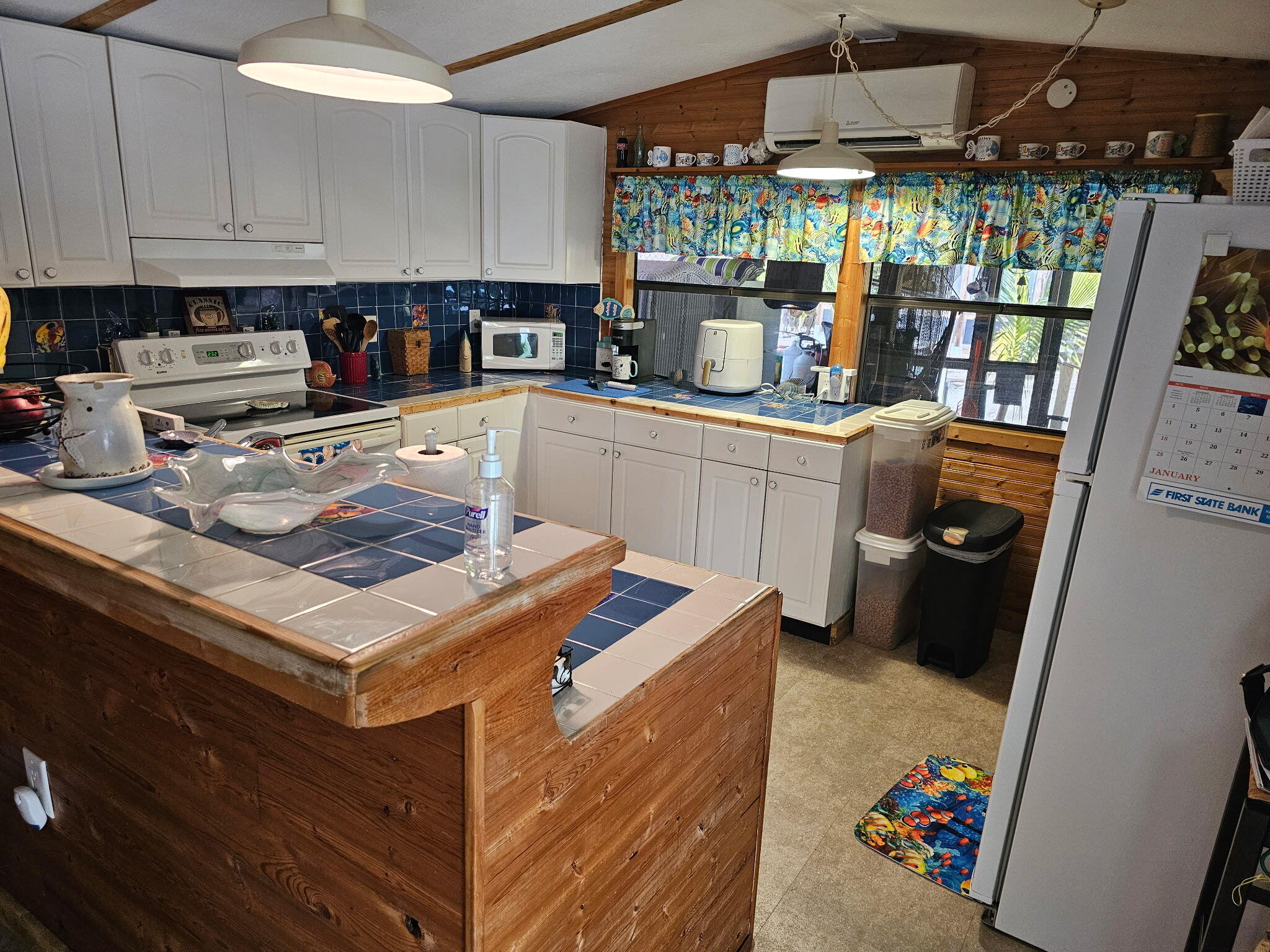 27997 Coral Shores Road Summerland Key, FL 33042 - Photo 13 of 28 a kitchen with a stove and a refrigerator