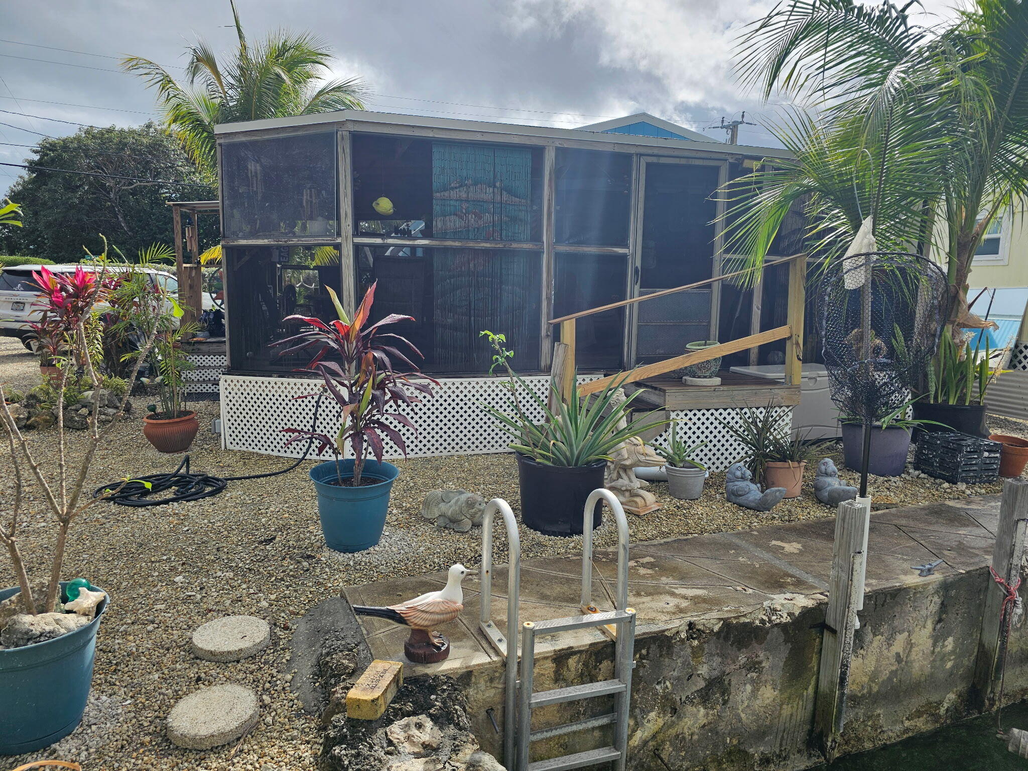 27997 Coral Shores Road Summerland Key, FL 33042 - Photo 2 of 28 a potted plant sitting in front of a house