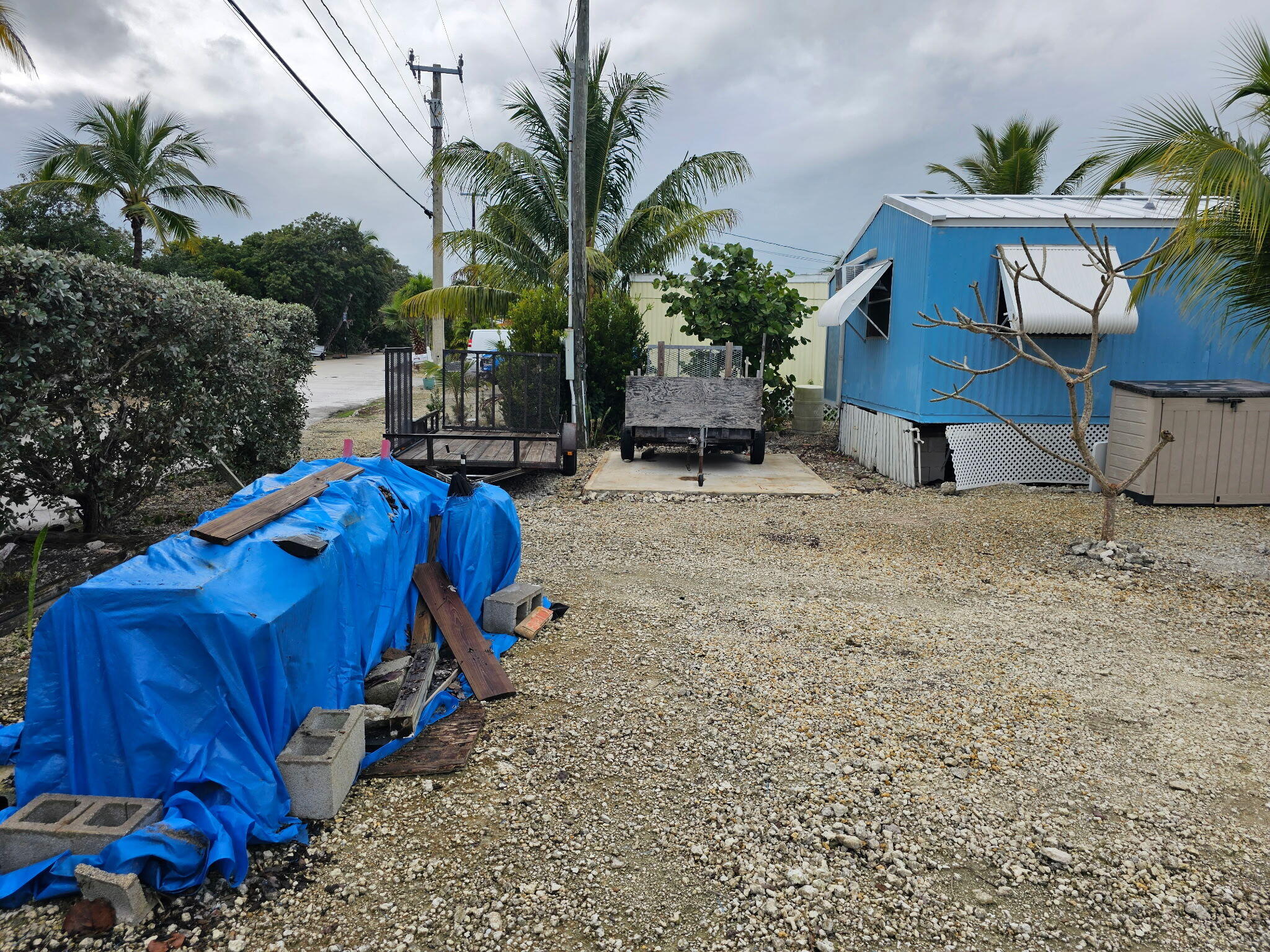 27997 Coral Shores Road Summerland Key, FL 33042 - Photo 26 of 28 a view of a backyard with a patio and potted plants