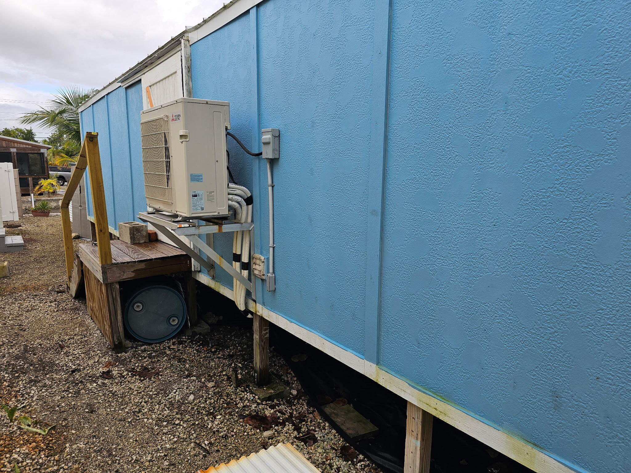 27997 Coral Shores Road Summerland Key, FL 33042 - Photo 28 of 28 a room with water heater and wooden cabinets