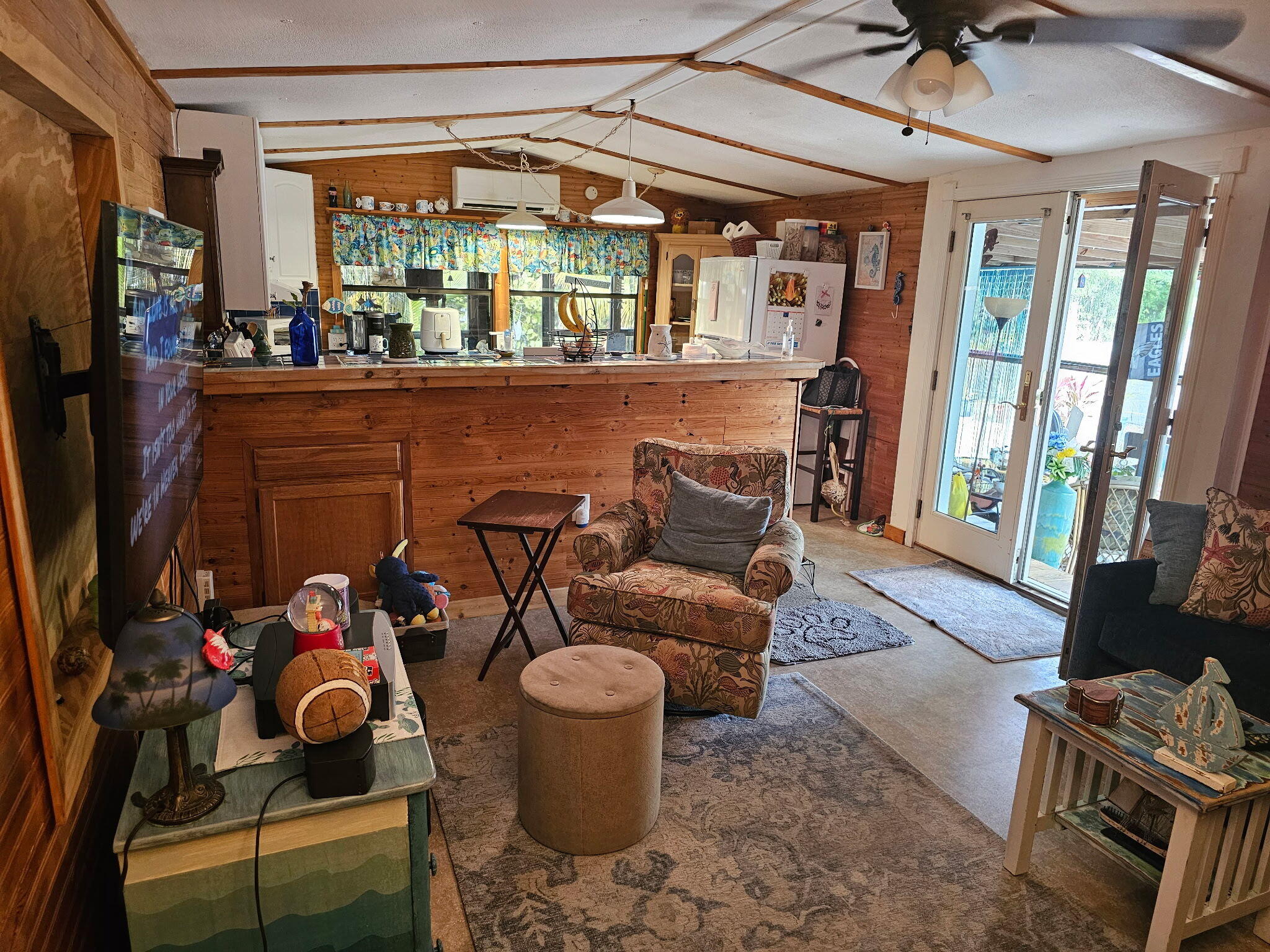 27997 Coral Shores Road Summerland Key, FL 33042 - Photo 9 of 28 a living room with furniture a flat screen tv and a floor to ceiling window