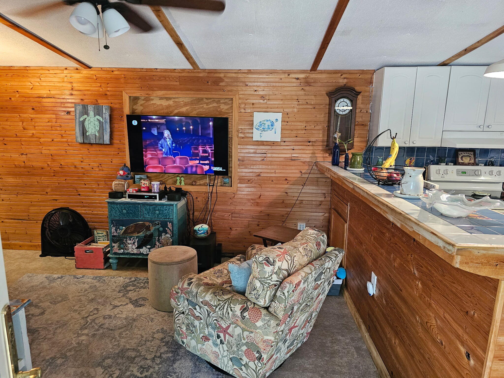 27997 Coral Shores Road Summerland Key, FL 33042 - Photo 10 of 28 a living room with furniture a flat screen tv and a fireplace