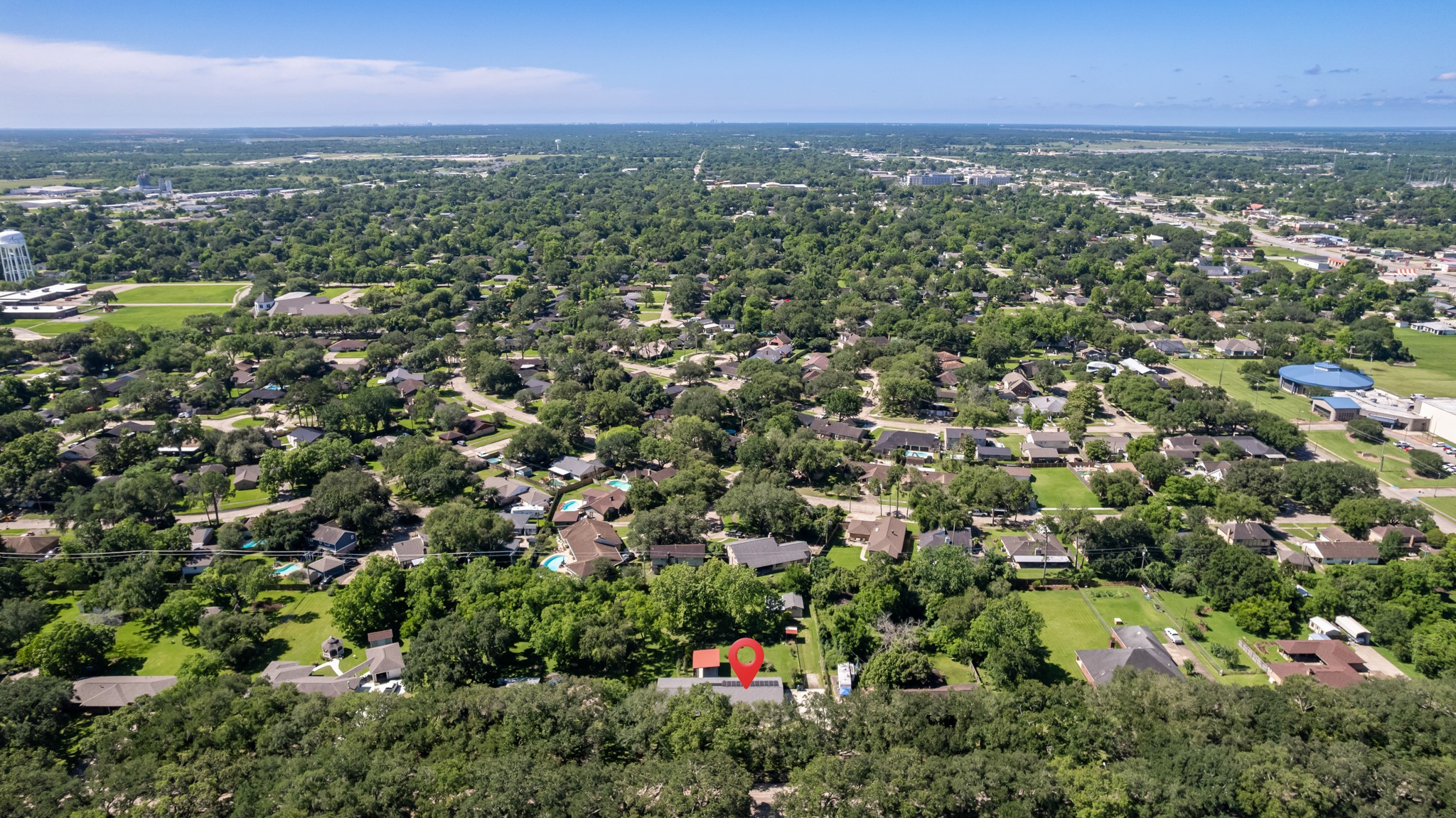 616 Cannan Drive Angleton, TX 77515 - Photo 45 of 49 Elevated aerial view showcases the property's location within an established neighborhood known for its mature tree canopy and spacious homesites. Conveniently situated near local amenities, schools, and major thoroughfares while maintaining a peaceful residential setting.