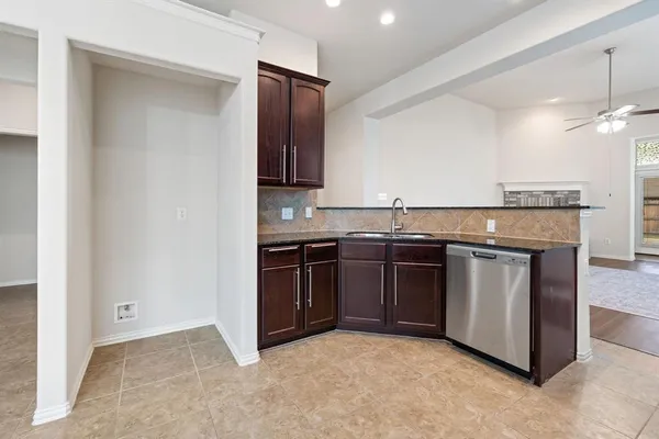 a kitchen with stainless steel appliances granite countertop a stove and a refrigerator