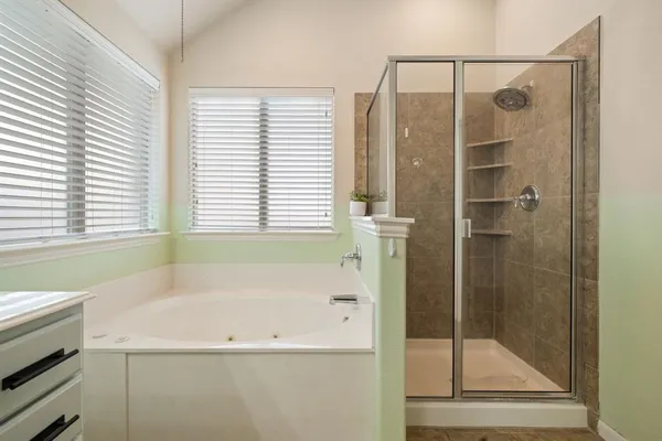 a bathroom with a bathtub and a shower