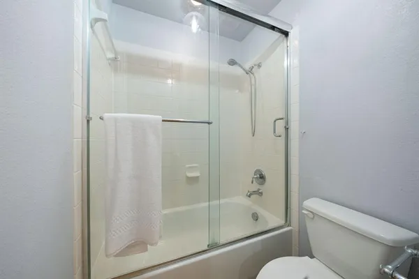a bathroom with a shower and toilet