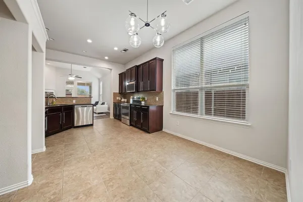 a large kitchen with stainless steel appliances granite countertop a stove and a sink