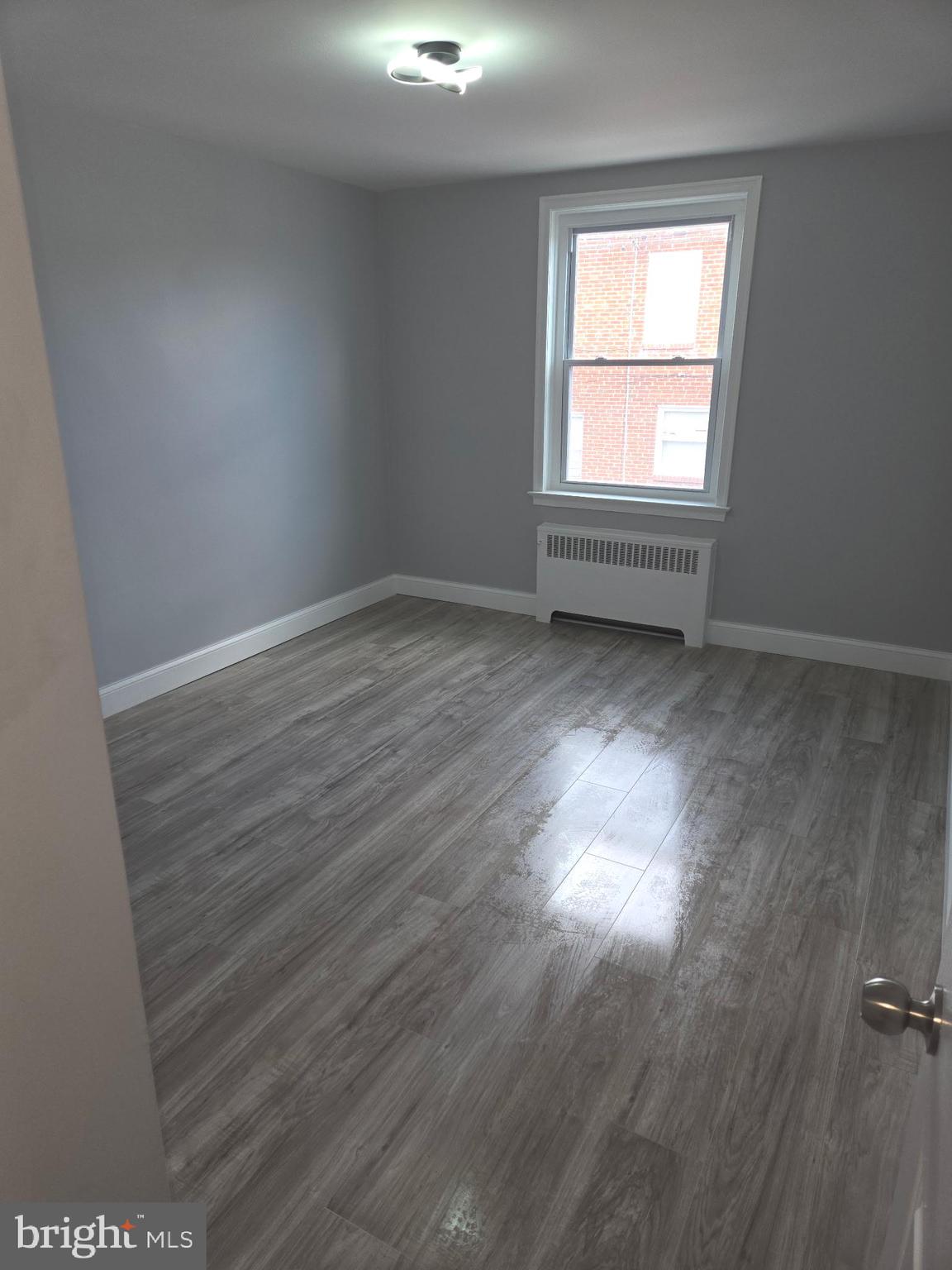 1531 Stevens Street Philadelphia, PA 19149 - Photo 12 of 25 an empty room with wooden floor and windows