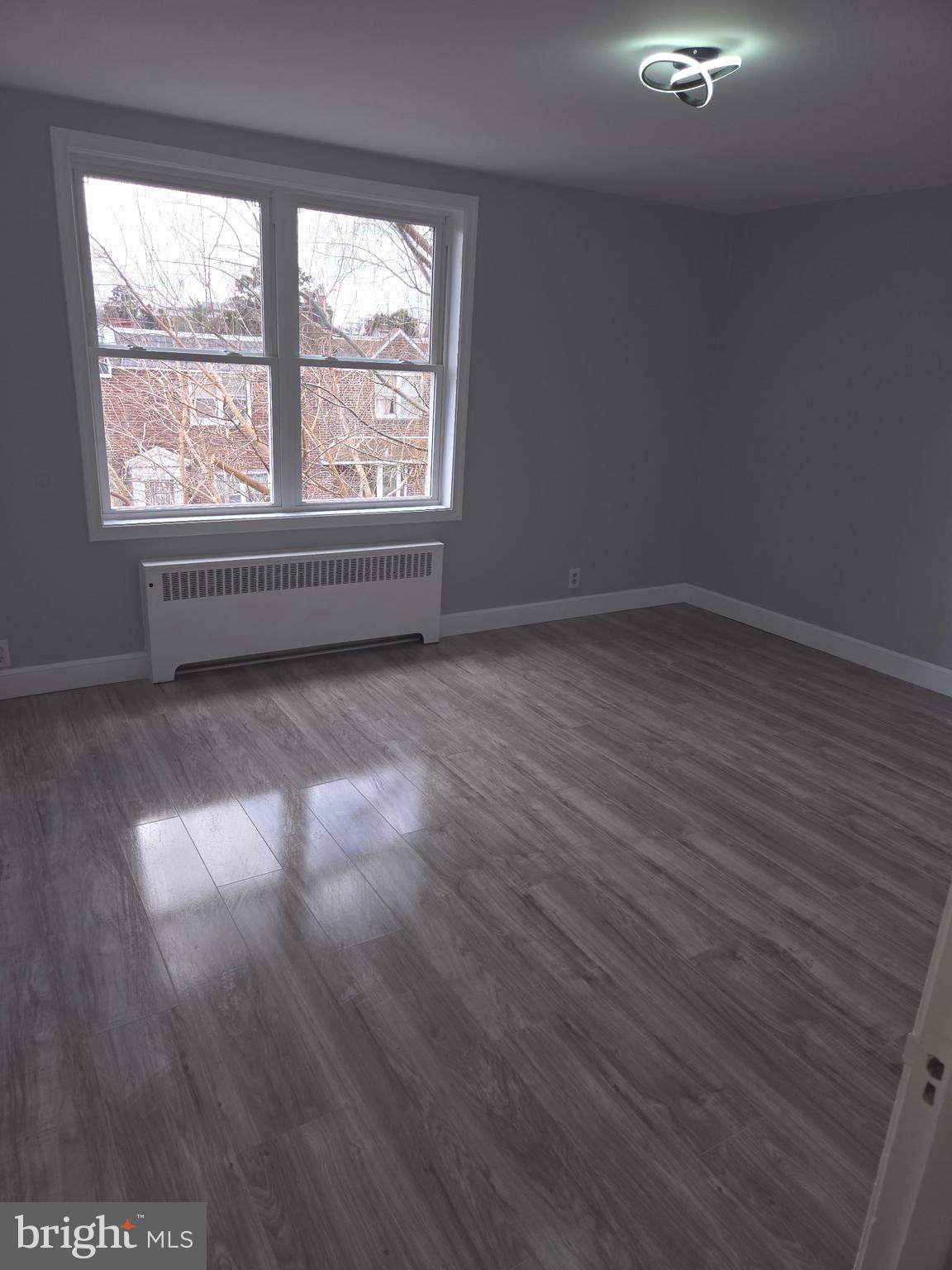 1531 Stevens Street Philadelphia, PA 19149 - Photo 17 of 25 a view of a room with wooden floor and window