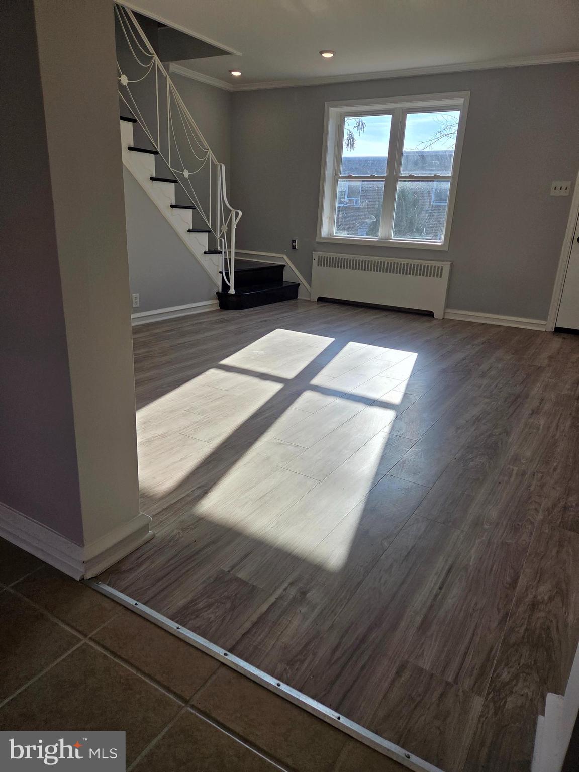 1531 Stevens Street Philadelphia, PA 19149 - Photo 18 of 25 a view of an empty room with wooden floor and windows