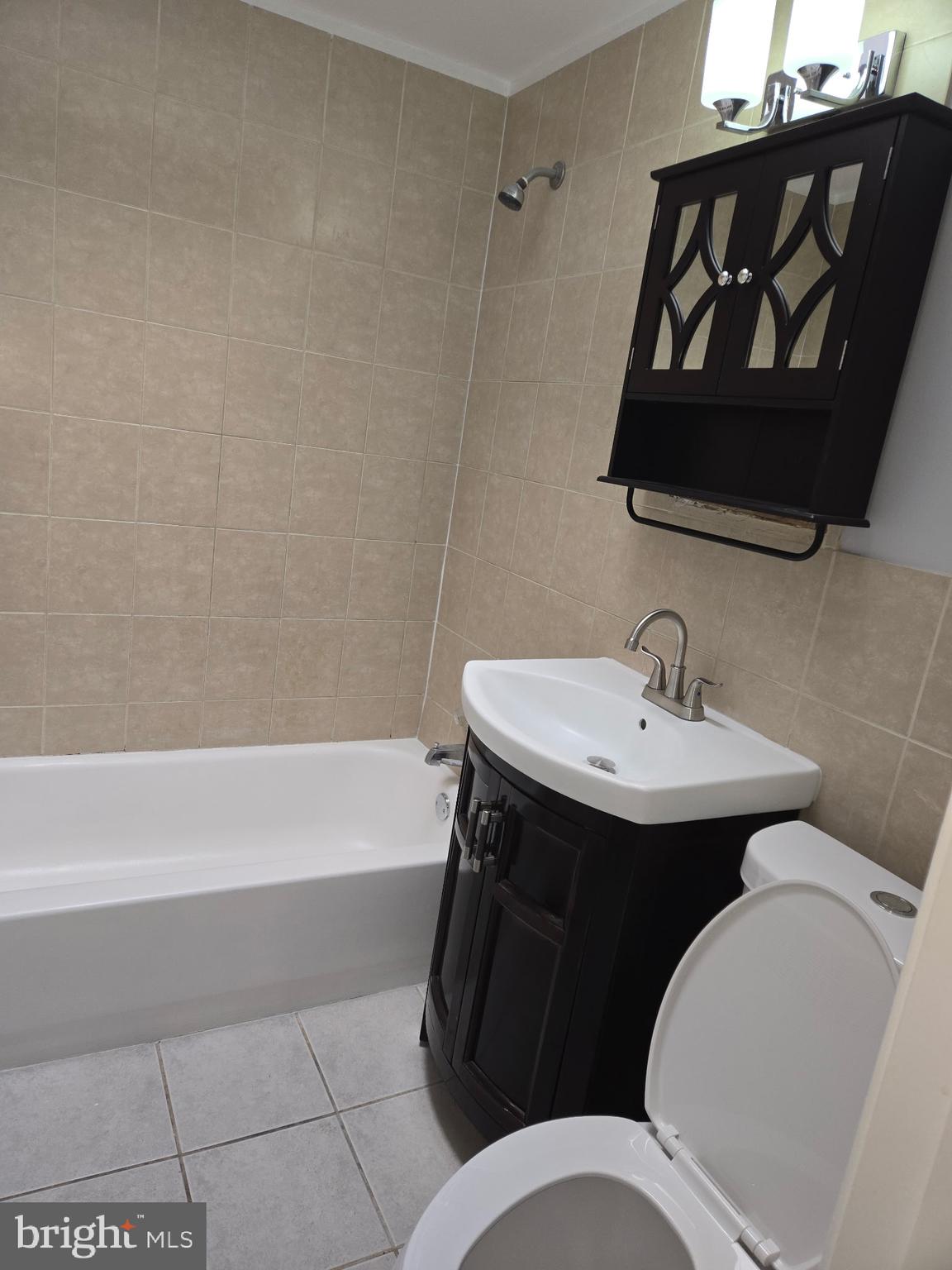 1531 Stevens Street Philadelphia, PA 19149 - Photo 19 of 25 a bathroom with a sink and a mirror