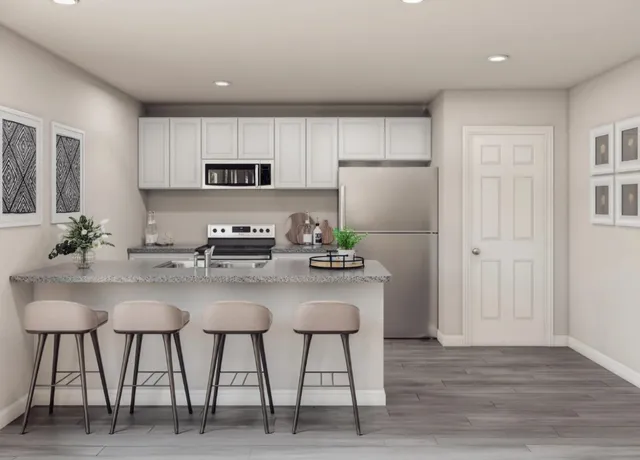 a kitchen with stainless steel appliances white cabinets and chairs
