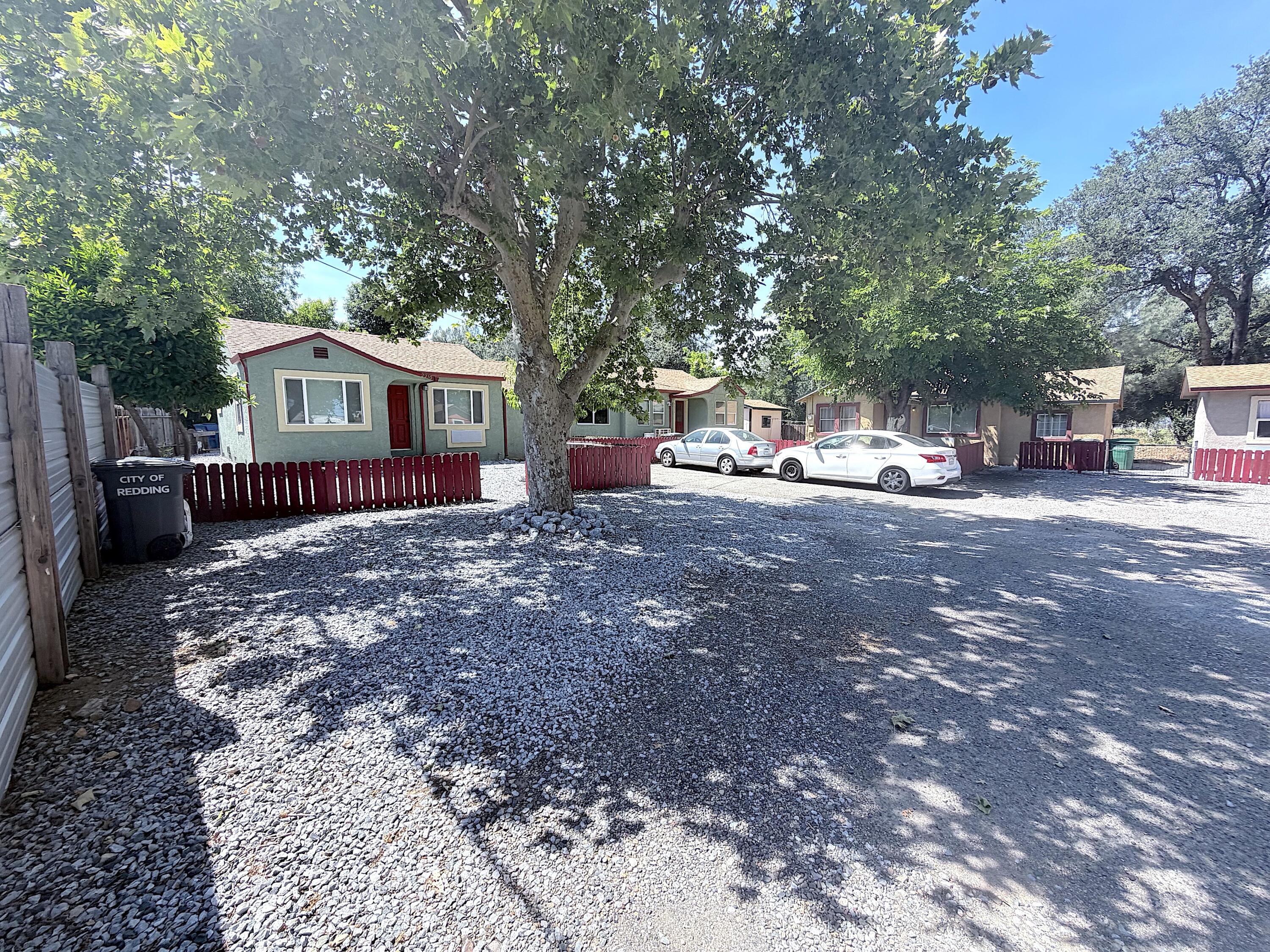 2230 El Reno Lane Redding, CA 96001 - Photo 26 of 27 a view of a house with a large tree and wooden fence