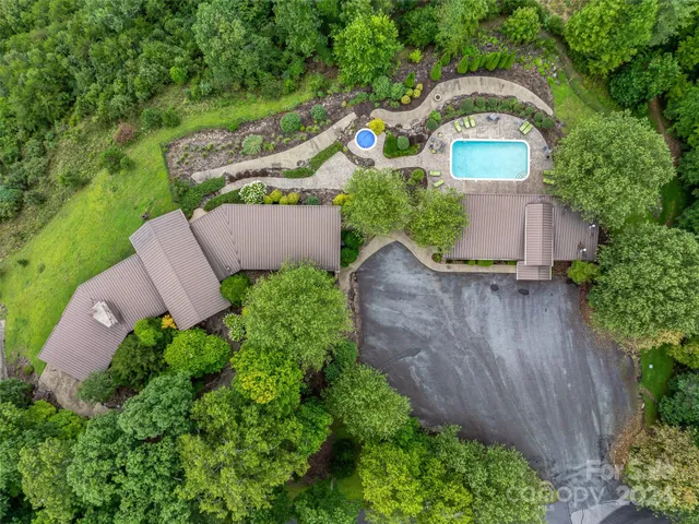 a view of a lush green outdoor space with a lake view