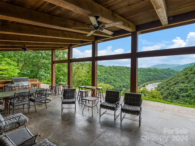 an aerial view of a house with yard and mountain view in back