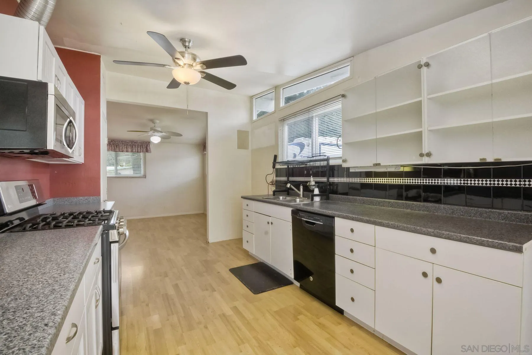 13816 Tobiasson Road Poway, CA 92064 - Photo 9 of 37 a kitchen with a sink stove and cabinets