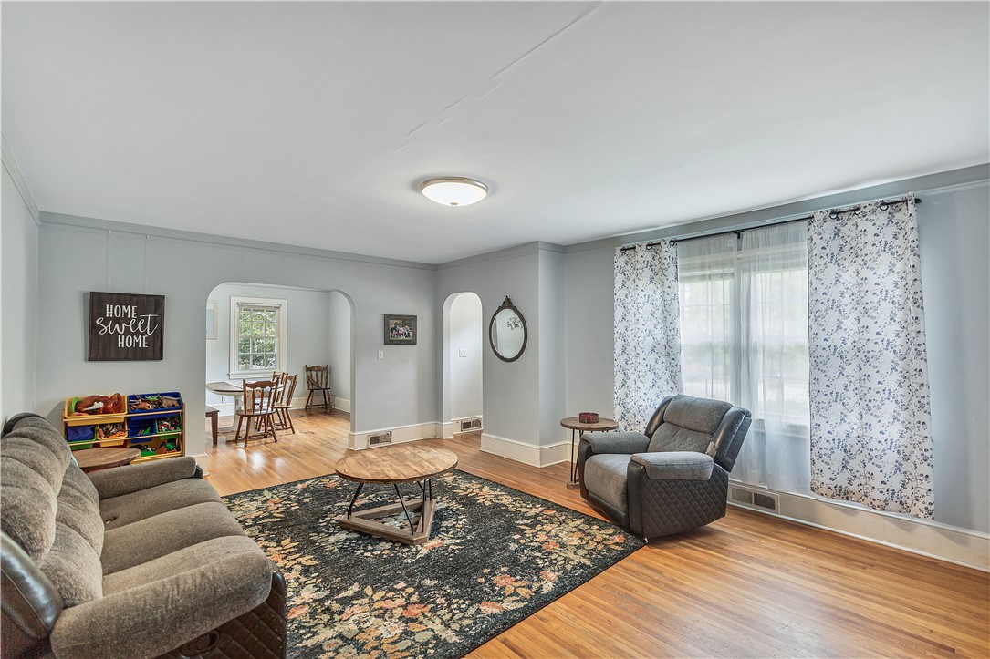 25 Central Avenue Honea Path, SC 29654 - Photo 12 of 29 This living room features gleaming hardwood floors and ample natural light, creating an inviting atmosphere.