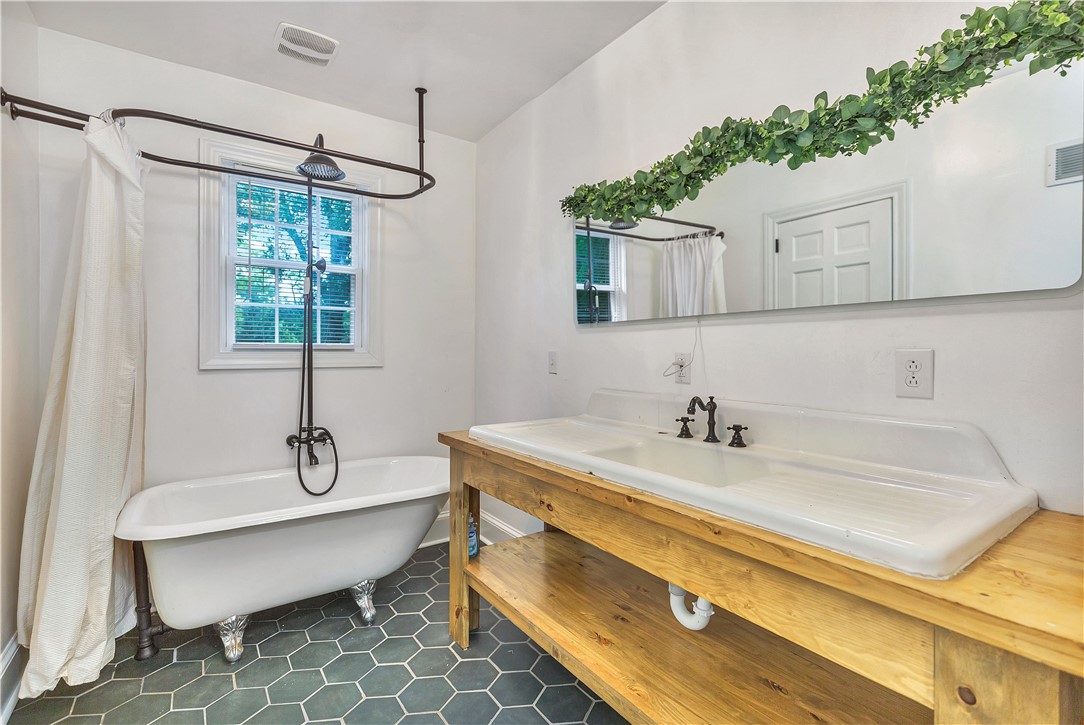 25 Central Avenue Honea Path, SC 29654 - Photo 15 of 36 This serene bathroom offers a spacious soaking tub and an expansive vanity.