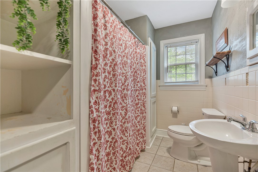 25 Central Avenue Honea Path, SC 29654 - Photo 15 of 29 This bright bathroom features ample storage, classic tile, and a refreshing ambiance.