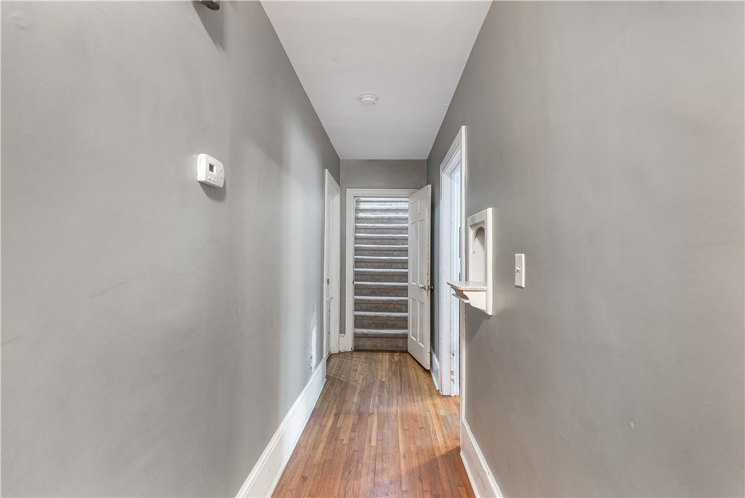 25 Central Avenue Honea Path, SC 29654 - Photo 16 of 29 This spacious hallway features rich hardwood flooring leading to an inviting staircase.