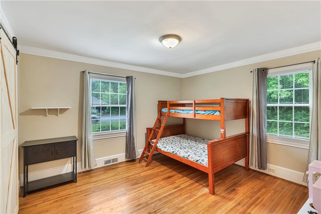 25 Central Avenue Honea Path, SC 29654 - Photo 18 of 36 This spacious room features ample natural light and durable flooring, offering a comfortable living space.