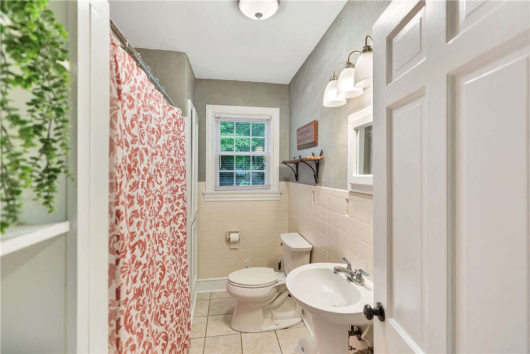 25 Central Avenue Honea Path, SC 29654 - Photo 19 of 36 This bright bathroom features natural light and practical tile finishes.