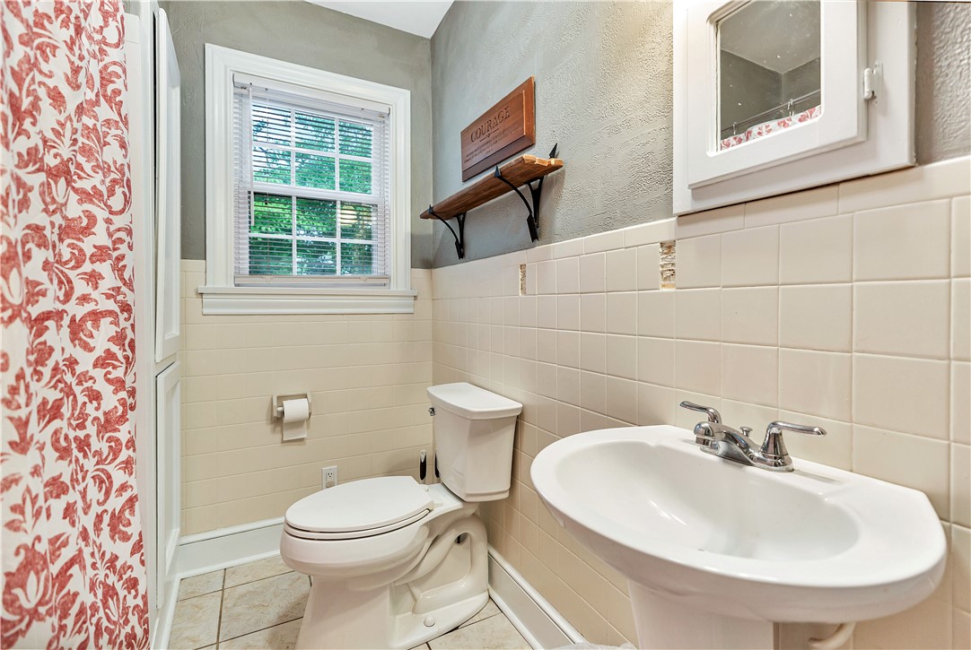 25 Central Avenue Honea Path, SC 29654 - Photo 20 of 36 This bright bathroom features classic tilework and a functional window.