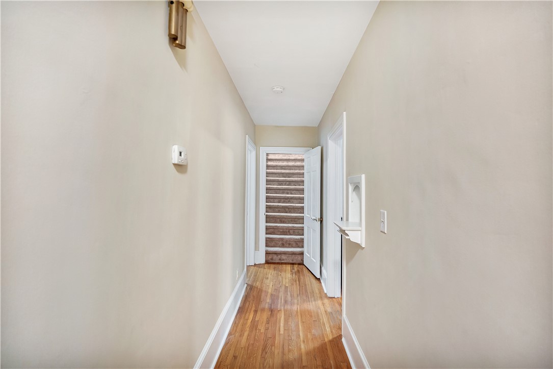 25 Central Avenue Honea Path, SC 29654 - Photo 21 of 36 This welcoming hallway features classic hardwood flooring, guiding you toward a carpeted staircase.