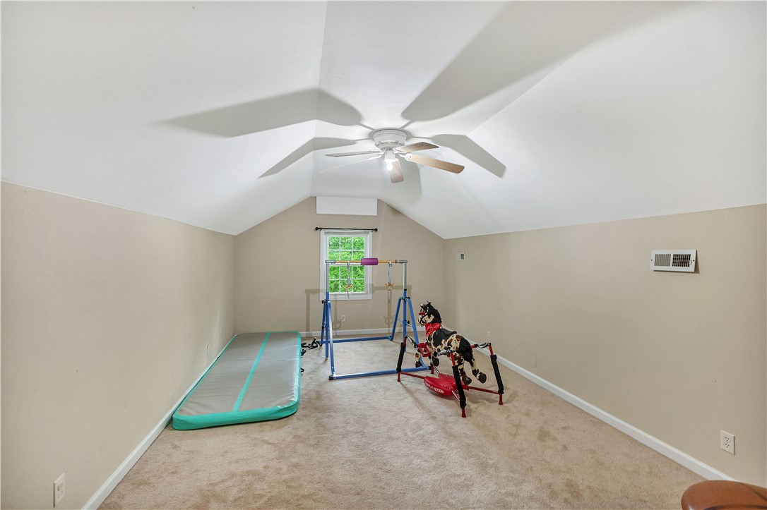 25 Central Avenue Honea Path, SC 29654 - Photo 25 of 36 This spacious bonus room features a vaulted ceiling, providing an airy and versatile living space.