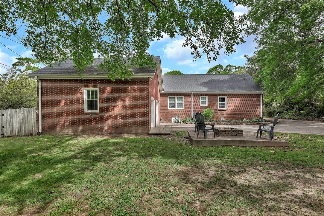 25 Central Avenue Honea Path, SC 29654 - Photo 27 of 29 This outdoor patio with a fire pit offers a perfect setting for gathering and relaxation.