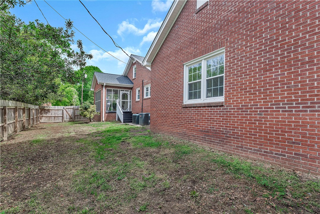 25 Central Avenue Honea Path, SC 29654 - Photo 29 of 29 This spacious backyard offers privacy and room for outdoor activities, complementing the classic brick exterior.