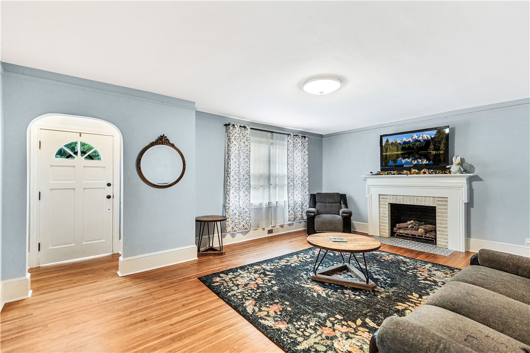 25 Central Avenue Honea Path, SC 29654 - Photo 3 of 36 This inviting living room features hardwood floors and a cozy fireplace, perfect for relaxing.