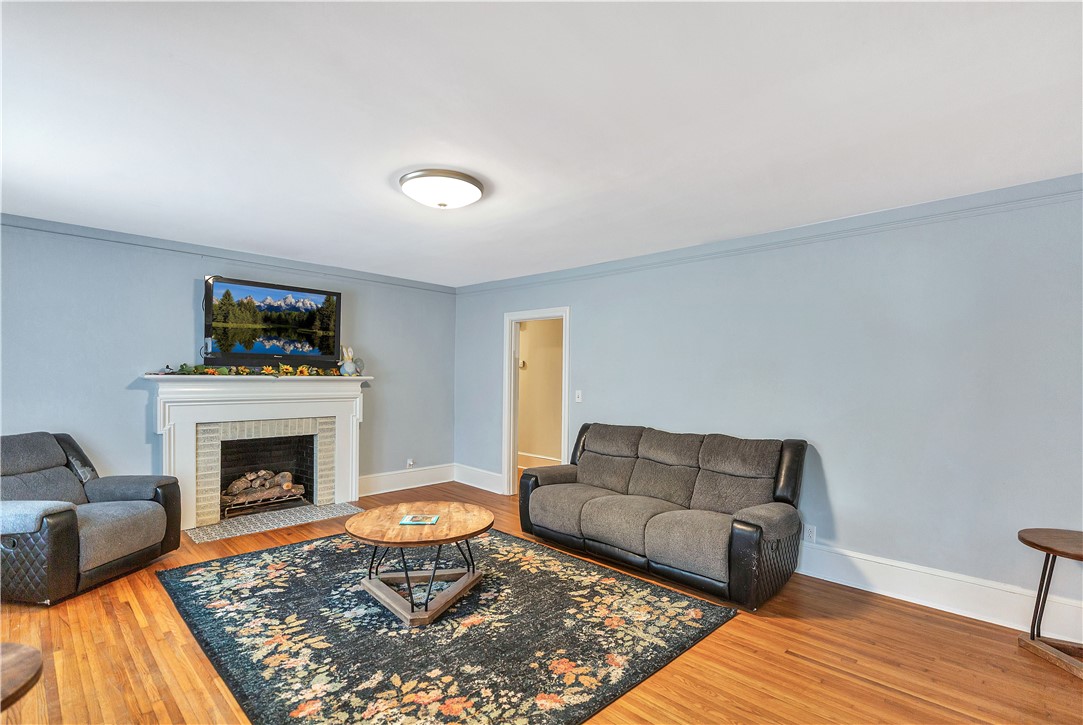 25 Central Avenue Honea Path, SC 29654 - Photo 4 of 36 This inviting living room boasts warm hardwood floors and a cozy fireplace.