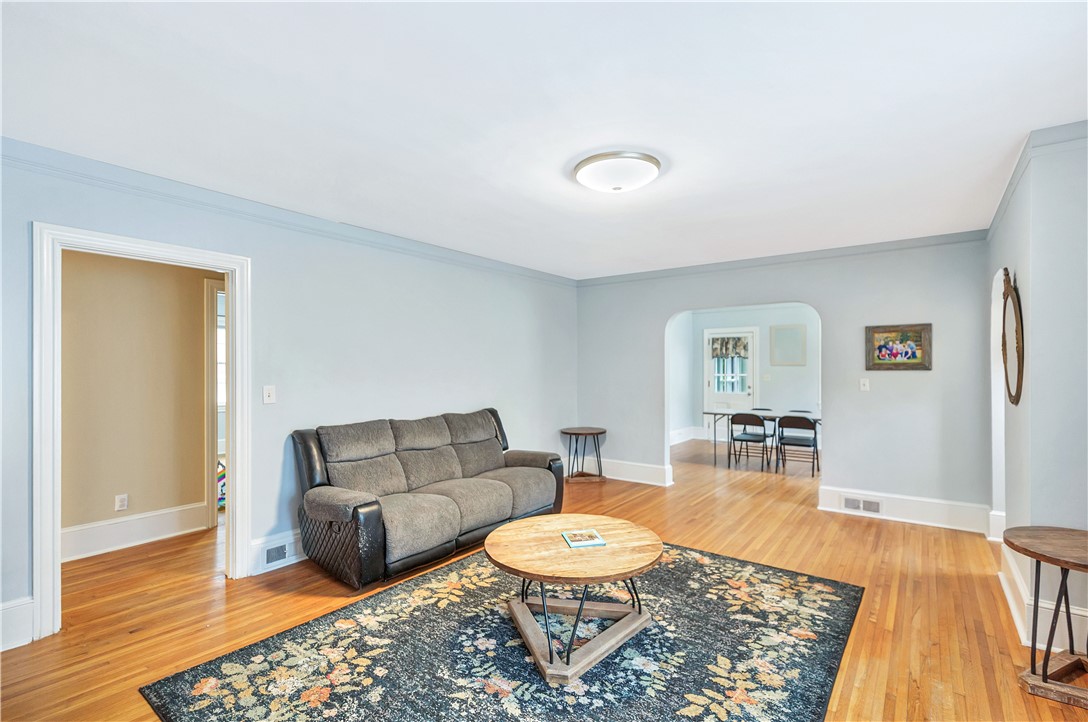 25 Central Avenue Honea Path, SC 29654 - Photo 5 of 36 This inviting living space features warm wood floors and ample natural light, perfect for everyday living.