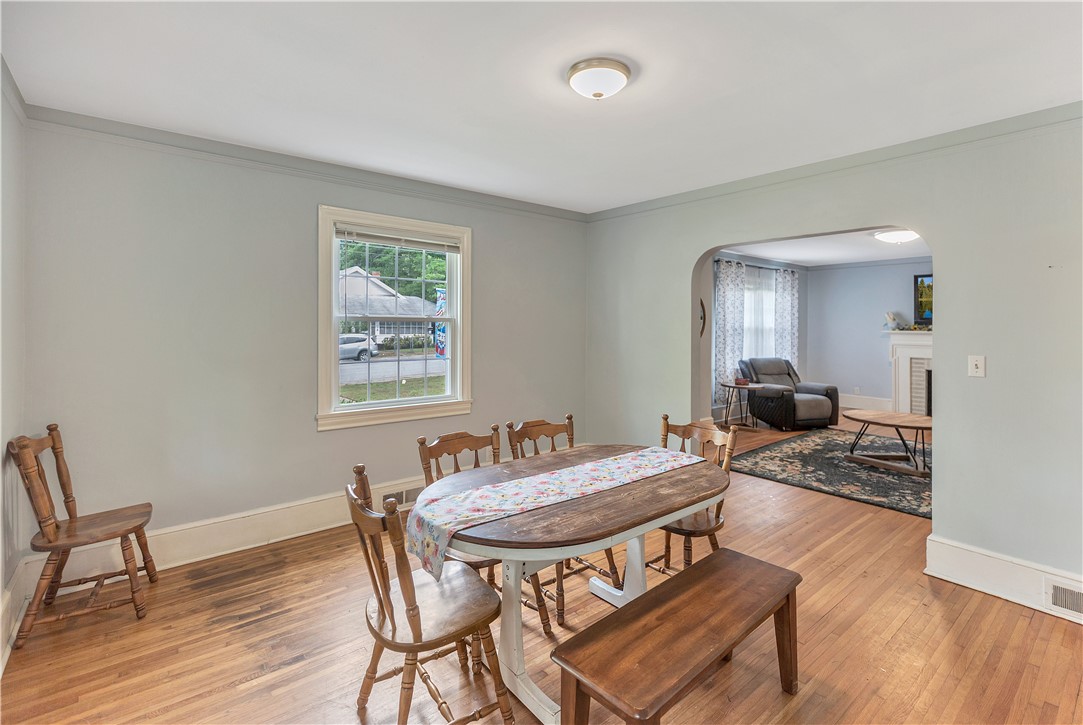 25 Central Avenue Honea Path, SC 29654 - Photo 5 of 29 This bright dining room features hardwood floors and opens into a comfortable living area.