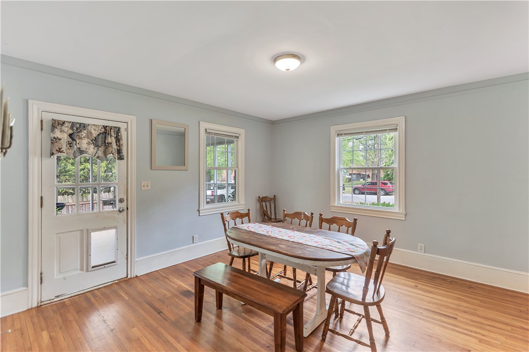 25 Central Avenue Honea Path, SC 29654 - Photo 6 of 29 This inviting dining room features hardwood floors and ample natural light, creating a comfortable atmosphere.