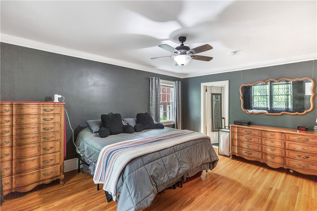 25 Central Avenue Honea Path, SC 29654 - Photo 9 of 29 This inviting bedroom features rich hardwood flooring and a ceiling fan for optimal comfort.