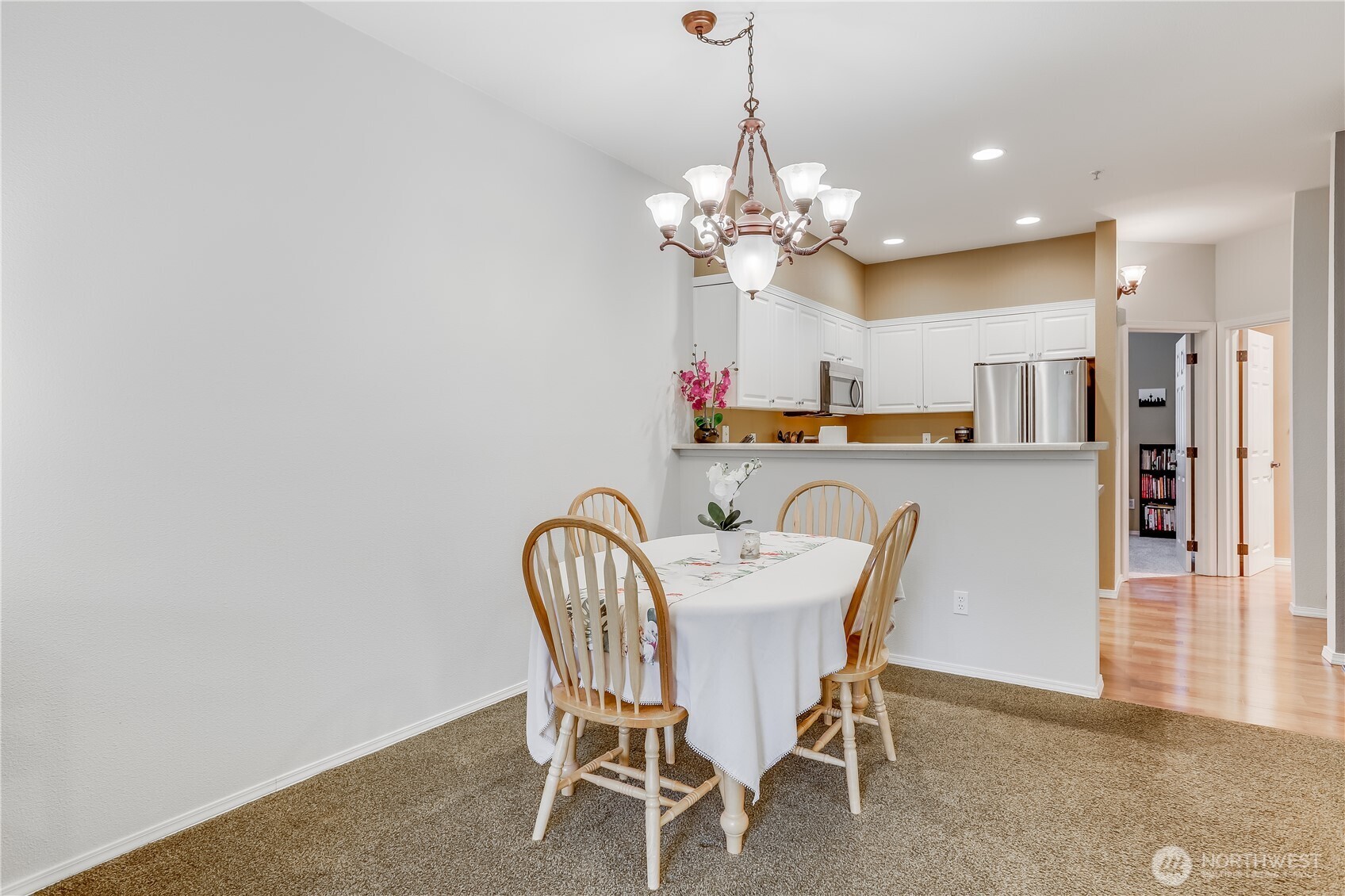 1800 Northeast 40th Street, Unit G5 Renton, WA 98056 - Photo 13 of 30 a view of a dining room with furniture and chandelier