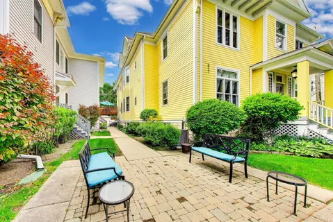 a front view of a residential houses with yard and green space