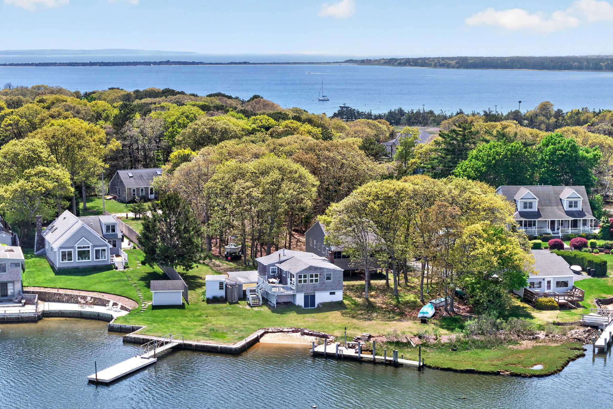 11 Clamshell Lane Mashpee, MA 02649 - Photo 2 of 43 a view of a swimming pool with lawn chairs under an umbrella