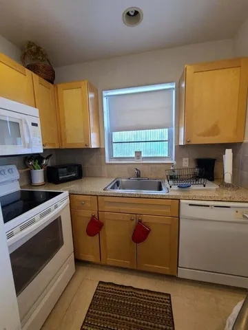 a kitchen with stainless steel appliances a stove a sink and a microwave