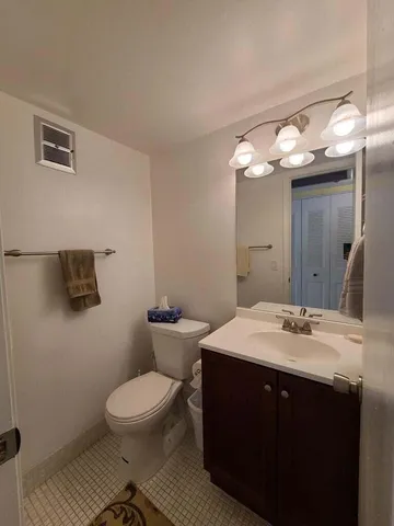 a bathroom with a toilet a sink and mirror