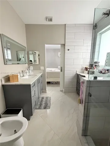 a bathroom with a toilet sink and mirror