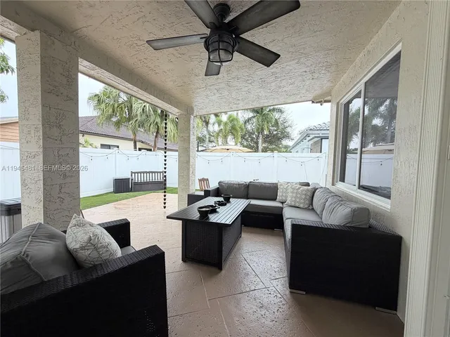 a living room with furniture and a bed