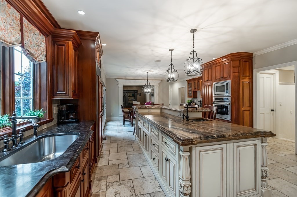 9 Prides Circle Andover, MA 01810 - Photo 14 of 42 a kitchen with stainless steel appliances granite countertop a sink a stove and a wooden cabinets