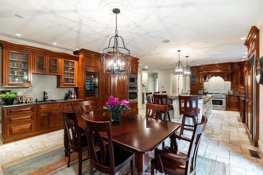9 Prides Circle Andover, MA 01810 - Photo 15 of 42 a dining room with furniture a chandelier and wooden floor